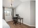 This bedroom includes wood floors, a chandelier, and a workstation next to the window at 12281 E Tennessee Dr # 303, Aurora, CO 80012