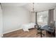 This bedroom includes wood floors, a chandelier, a single bed, and a workstation next to the window at 12281 E Tennessee Dr # 303, Aurora, CO 80012
