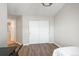 This bedroom includes wood floors, closet doors, a chandelier, a single bed, and a workstation at 12281 E Tennessee Dr # 303, Aurora, CO 80012