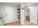 Hallway view features white door, open shelving and easy access to rooms at 12281 E Tennessee Dr # 303, Aurora, CO 80012