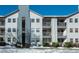 The building exterior features multiple balconies and snow covered landscaping at 12281 E Tennessee Dr # 303, Aurora, CO 80012