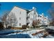 A sunny view of apartments with balconies and snow-covered landscaping on a winter day at 12281 E Tennessee Dr # 303, Aurora, CO 80012
