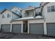 Garage with stairways to apartment balconies in a residential complex with snow at 12281 E Tennessee Dr # 303, Aurora, CO 80012