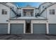 Garages with stairways to apartment balconies in a residential complex with snow at 12281 E Tennessee Dr # 303, Aurora, CO 80012