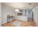 View of the kitchen, featuring granite countertops, white cabinets, and seamless flow to dining area at 12281 E Tennessee Dr # 303, Aurora, CO 80012