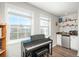 Cozy living area featuring a piano, bar area, and large windows at 12281 E Tennessee Dr # 303, Aurora, CO 80012