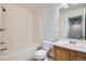 Standard full bathroom showcasing a shower-tub combo, toilet, and vanity with large mirror at 897 Mockingbird Ln, Brighton, CO 80601
