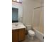 Well-lit bathroom features a vanity, toilet, and a shower-tub combination with a clean and functional design at 897 Mockingbird Ln, Brighton, CO 80601