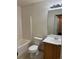 The well-lit bathroom includes a vanity, toilet, and a shower-tub combination, offering essential amenities at 897 Mockingbird Ln, Brighton, CO 80601