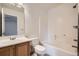 Standard bathroom featuring shower-tub combo and oak cabinets at 897 Mockingbird Ln, Brighton, CO 80601