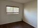 Simple bedroom with hardwood floors, a window for natural light, and neutral walls for easy customization at 897 Mockingbird Ln, Brighton, CO 80601