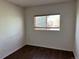 Another bedroom featuring neutral colors, hardwood floors, and a window offering plenty of natural light at 897 Mockingbird Ln, Brighton, CO 80601