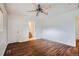 Spacious bedroom featuring a ceiling fan, wood flooring, and ensuite bath at 897 Mockingbird Ln, Brighton, CO 80601
