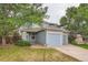Two-story home features blue siding, beige trim, dual garages, and landscaping at 897 Mockingbird Ln, Brighton, CO 80601