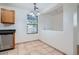 An efficient kitchen features tile flooring, oak cabinets, black countertops, and appliances at 897 Mockingbird Ln, Brighton, CO 80601