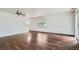 Open concept living room features hardwood floors, neutral paint, ceiling fan and stairway at 897 Mockingbird Ln, Brighton, CO 80601