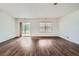 Open concept living room features hardwood floors, neutral paint, sliding glass door to patio at 897 Mockingbird Ln, Brighton, CO 80601