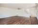 Open concept living room features hardwood floors, neutral paint, ceiling fan and stairway at 897 Mockingbird Ln, Brighton, CO 80601