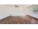 Open concept living room features hardwood floors, neutral paint, ceiling fan and stairway at 897 Mockingbird Ln, Brighton, CO 80601