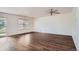 Open concept living room features hardwood floors, neutral paint, and a ceiling fan at 897 Mockingbird Ln, Brighton, CO 80601