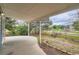 Covered patio overlooking a backyard featuring a wooden fence and mature trees and landscaping at 897 Mockingbird Ln, Brighton, CO 80601