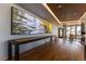 Modern hallway featuring a shuffleboard table, an art piece, and access to a rooftop dining area at 1750 Wewatta St # 705, Denver, CO 80202