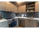 The modern kitchen features light wood cabinets, stainless steel appliances, white countertops and a dark backsplash at 1750 Wewatta St # 705, Denver, CO 80202