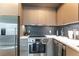 This contemporary kitchen showcases stainless steel appliances and black hexagonal tile backsplash at 1750 Wewatta St # 705, Denver, CO 80202