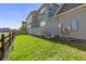 Spacious backyard with green grass, a wooden fence and wooden deck providing ample room for outdoor activities at 1678 Wright Aly, Erie, CO 80516