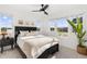 Light-filled bedroom with large windows, black furniture and calming decor creating a relaxing atmosphere at 1678 Wright Aly, Erie, CO 80516