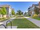 View of the sidewalk with grass on each side and neighborhood houses and trees under a clear blue sky at 1678 Wright Aly, Erie, CO 80516