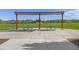 View of a common area pergola with picnic tables, a grassy field and houses under a clear blue sky at 1678 Wright Aly, Erie, CO 80516