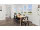 Bright dining room with wood floors, multiple windows and modern table and chairs set at 1678 Wright Aly, Erie, CO 80516