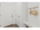 Entryway with white walls and a bench with hat rack at 1678 Wright Aly, Erie, CO 80516