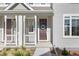 Close up of front porch and door adorned with a wreath, offering curb appeal at 1678 Wright Aly, Erie, CO 80516