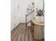 Hallway leading to stairs with wooden banister and table with mirror at 1678 Wright Aly, Erie, CO 80516