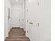 Hallway with hardwood floors, multiple doors and neutral colored walls at 1678 Wright Aly, Erie, CO 80516