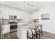 Stylish kitchen with granite countertops, stainless steel appliances, and a breakfast bar at 1678 Wright Aly, Erie, CO 80516