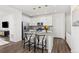 Modern kitchen with white cabinetry, stainless steel appliances, and a convenient island at 1678 Wright Aly, Erie, CO 80516