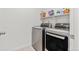 Convenient laundry room with modern washer and dryer, plus storage shelf for detergents at 1678 Wright Aly, Erie, CO 80516