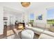 Sunlit living room with open floor plan, seamlessly connected to the dining area at 1678 Wright Aly, Erie, CO 80516