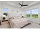 Bright main bedroom with large windows, side tables and a ceiling fan at 1678 Wright Aly, Erie, CO 80516