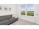 Bright sitting room with gray sofa and great backyard views at 1678 Wright Aly, Erie, CO 80516