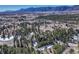 Stunning aerial view of a home nestled among lush greenery with mountain views at 17015 Oxbridge Rd, Monument, CO 80132