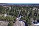 Aerial view showcasing the vast property surrounded by lush greenery and open fields at 17015 Oxbridge Rd, Monument, CO 80132