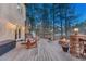 Outdoor deck with wood burning fire pit, seating, and treeline views perfect for relaxing at 17015 Oxbridge Rd, Monument, CO 80132