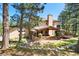 Stunning backyard with covered patio, stone accents, and lush landscaping at 17015 Oxbridge Rd, Monument, CO 80132