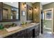 Elegant bathroom featuring a double vanity with granite countertops and framed mirrors at 17015 Oxbridge Rd, Monument, CO 80132