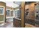 Luxurious bathroom with a soaking tub, stone shower, and picturesque windows at 17015 Oxbridge Rd, Monument, CO 80132