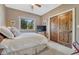 Cozy bedroom with large closet, ceiling fan, and a window offering natural light at 17015 Oxbridge Rd, Monument, CO 80132